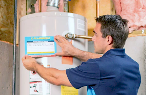 Z PLUMBERS tech servicing a hot water heater