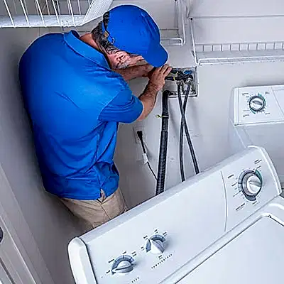 Service technician working on clothes washer