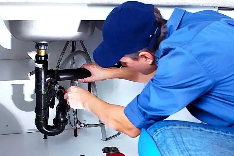 Technician working on kitchen sink