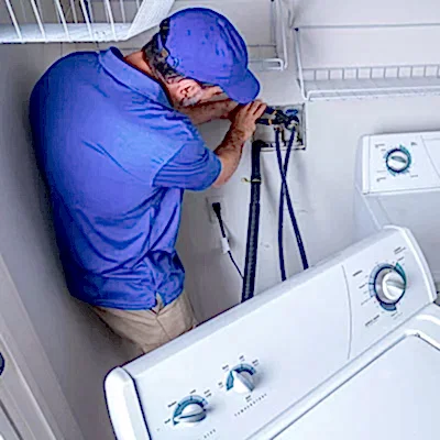 Service technician working on clothes washer