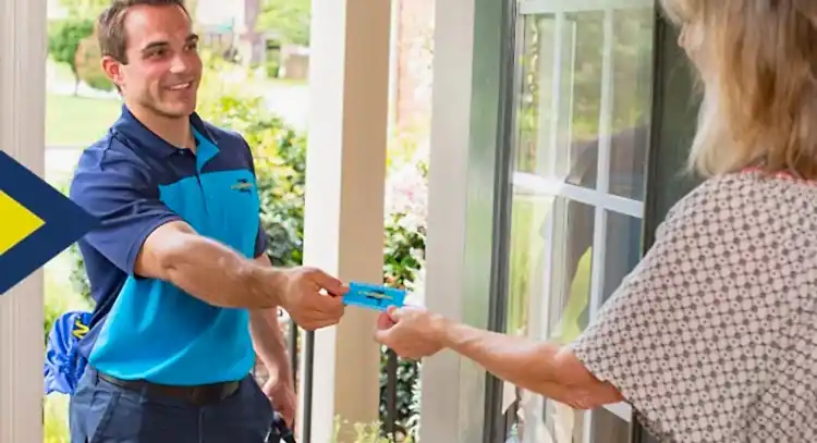Z Plumbers technician handing business card to female client