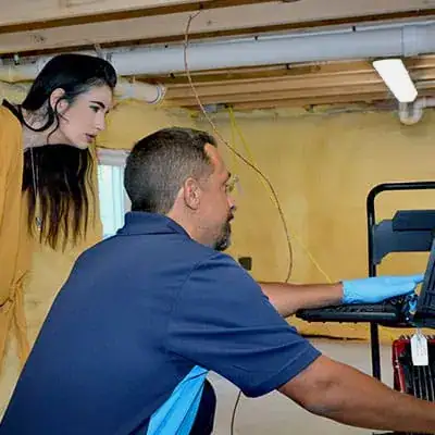 ZPZ Tech displaying progress on laptop to customer