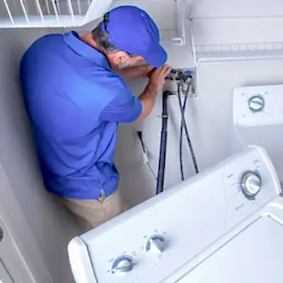 Service technician working on clothes washer