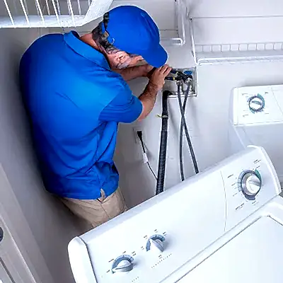 Service technician working on clothes washer