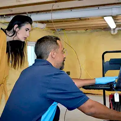 ZPZ Tech displaying progress on laptop to customer