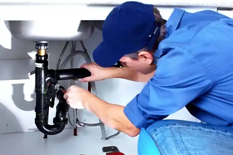 Technician working on kitchen sink