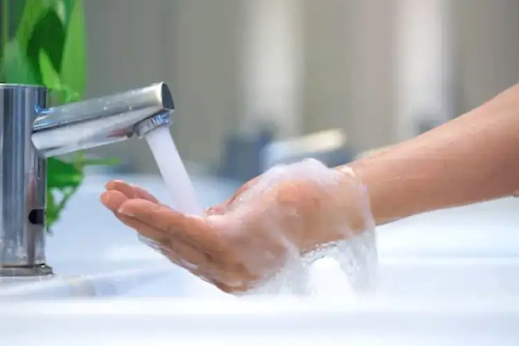 Faucet Streaming Water for Hot Water Heater Plumbing Services
