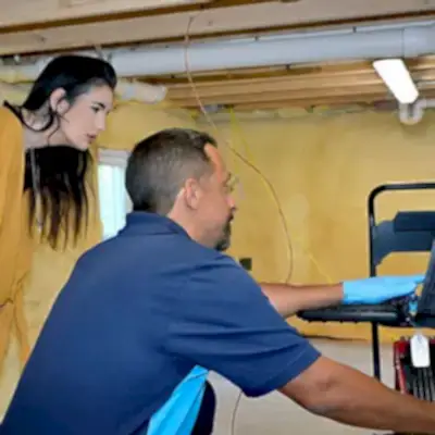 ZPZ Tech displaying progress on laptop to customer