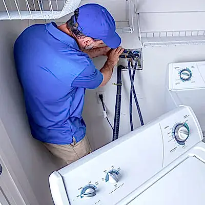 Service technician working on clothes washer