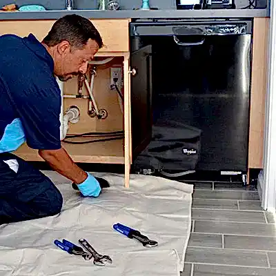 Z PLUMBERS service technician servicing dishwasher