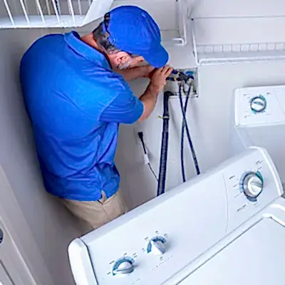 Service technician working on clothes washer