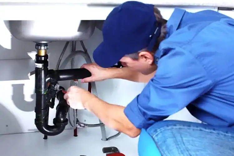 Technician working on kitchen sink