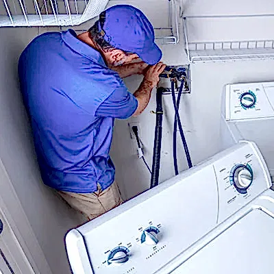 Service technician working on clothes washer