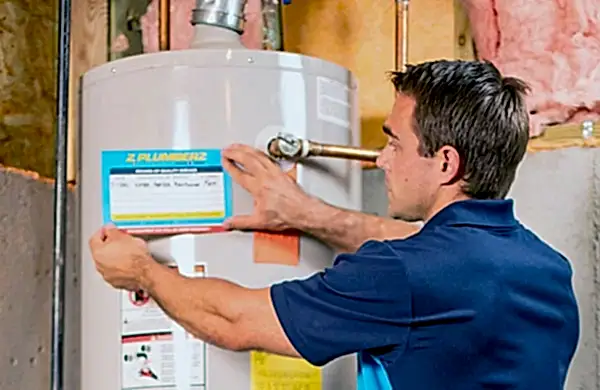 Z PLUMBERS tech servicing a hot water heater