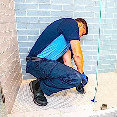 Z PLUMBERS service technician fixing shower drain