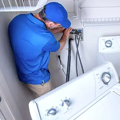 Service technician working on clothes washer