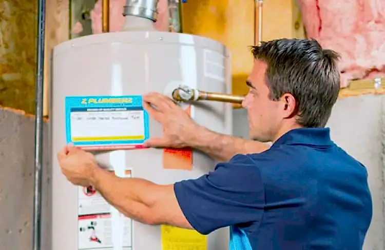 Z PLUMBERS tech servicing a hot water heater