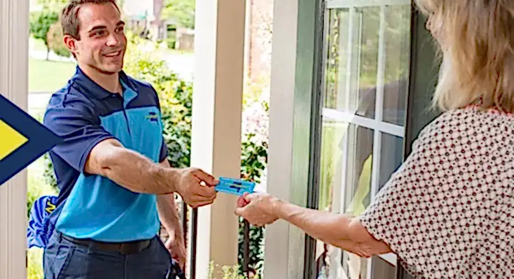 Z Plumbers technician handing business card to female client