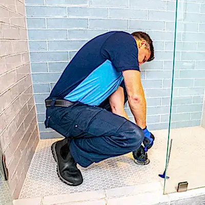 Z PLUMBERS service technician fixing shower drain