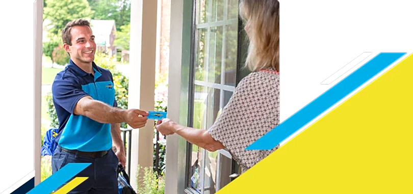 Z Plumberz technician handing a card to a customer