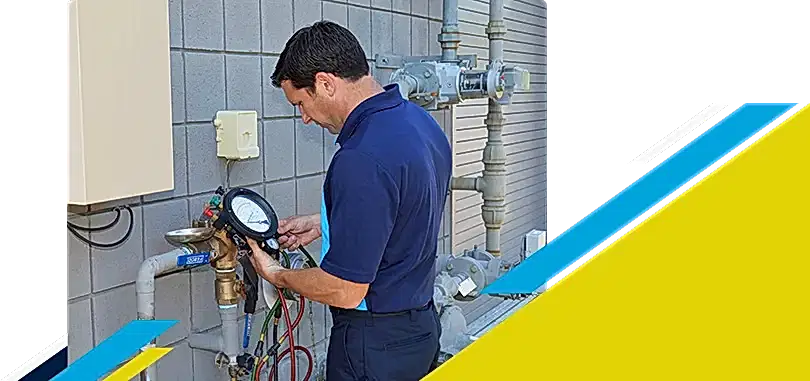 Z PLUMBERZ technician using a tool to measure backflow