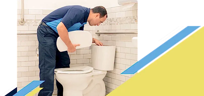 Z PLUMBERZ technician inspecting top chamber of a toilet