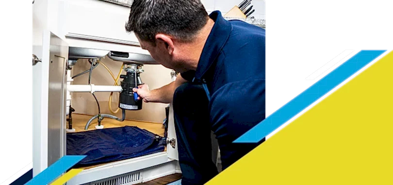 Z PLUMBERZ technician fixing garbage disposal