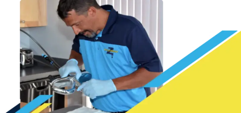 Z PLUMBERZ technician inspecting sink faucet assembly