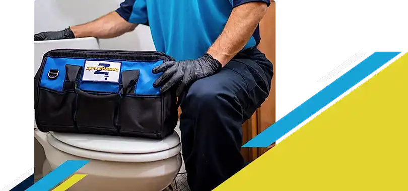 Z PLUMBERZ technician kneeling with tool bag on toilet