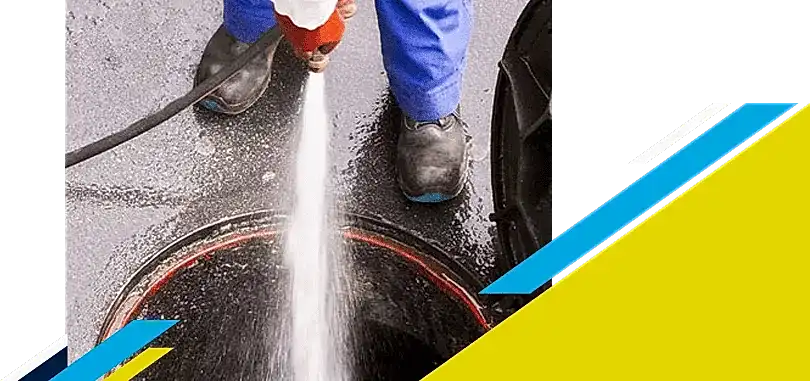 Z PLUMBERZ of Toledo technician spraying water down a manhole