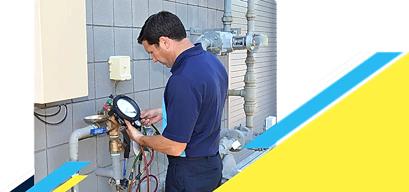 Z PLUMBERZ of Toledo technician using a tool to measure backflow