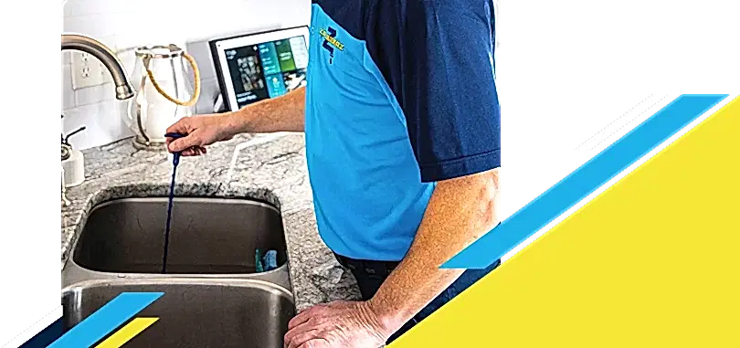 Z PLUMBERZ of Toledo technician unclogging drain 