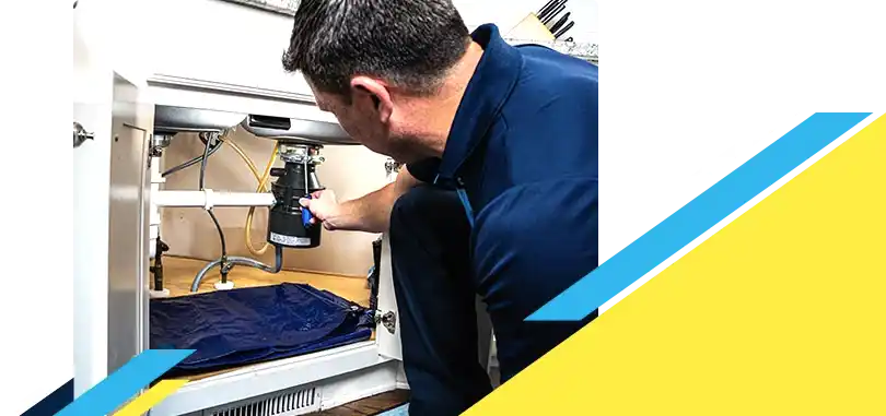 Z PLUMBERZ of Toledo technician fixing garbage disposal