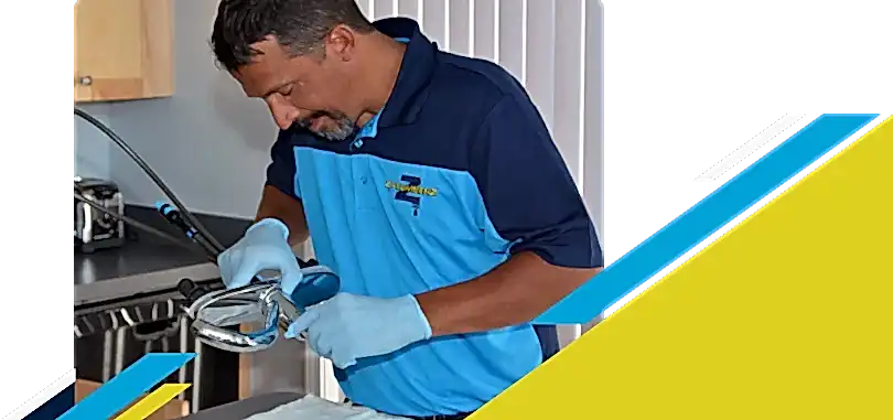 Z PLUMBERZ of Toledo technician inspecting sink faucet assembly