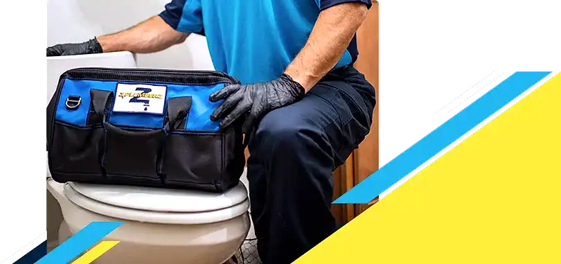 Z PLUMBERZ of Toledo technician kneeling with tool bag on toilet