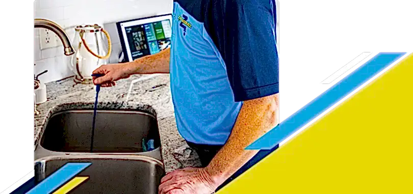 Z PLUMBERZ of Palm Beach technician unclogging drain 