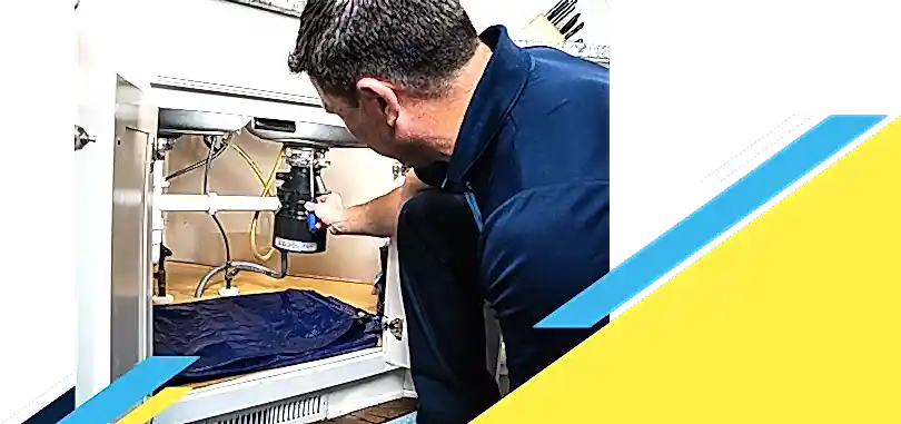 Z PLUMBERZ of Palm Beach technician fixing garbage disposal