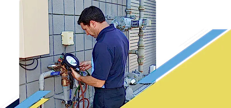 Z PLUMBERZ of North Dallas technician using a tool to measure backflow