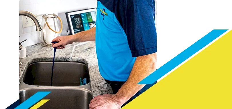 Z PLUMBERZ of North Dallas technician unclogging drain 