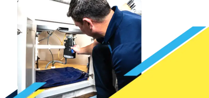 Z PLUMBERZ of North Dallas technician fixing garbage disposal