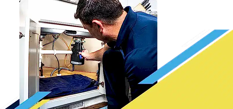 Z PLUMBERZ of Macomb technician fixing garbage disposal