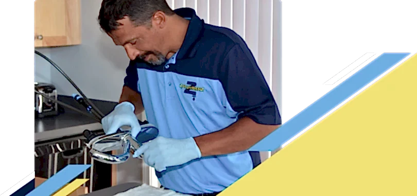 Z PLUMBERZ of Macomb technician inspecting sink faucet assembly