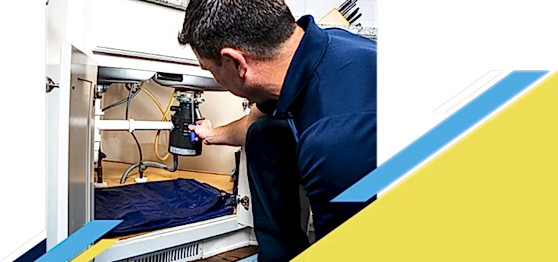 Z PLUMBERZ of New Haven technician fixing garbage disposal
