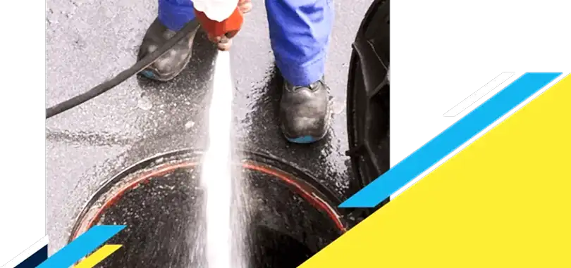 Z PLUMBERZ of Ann Arbor technician spraying water down a manhole