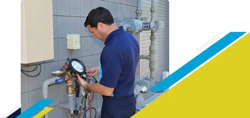 Z PLUMBERZ of Ann Arbor technician using a tool to measure backflow