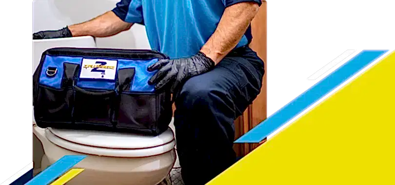 Z PLUMBERZ of Ann Arbor technician kneeling with tool bag on toilet