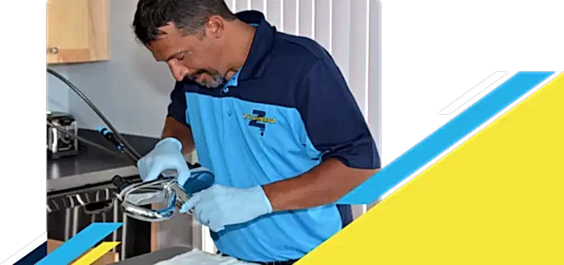 Z PLUMBERZ of Downriver technician inspecting sink faucet assembly
