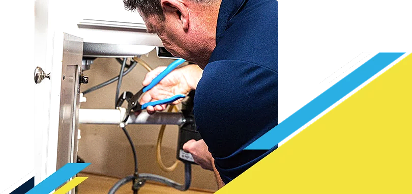 Z PLUMBERZ of North America technician fixing pipe under a sink