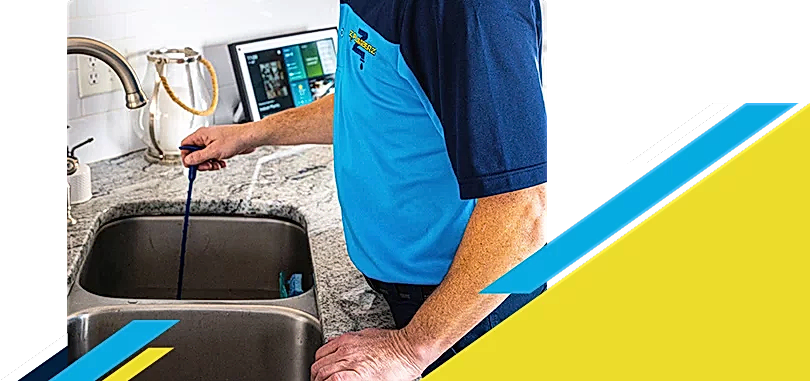 Z PLUMBERZ of North America technician unclogging drain 