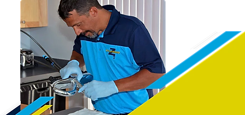 Z PLUMBERZ of North America technician inspecting sink faucet assembly